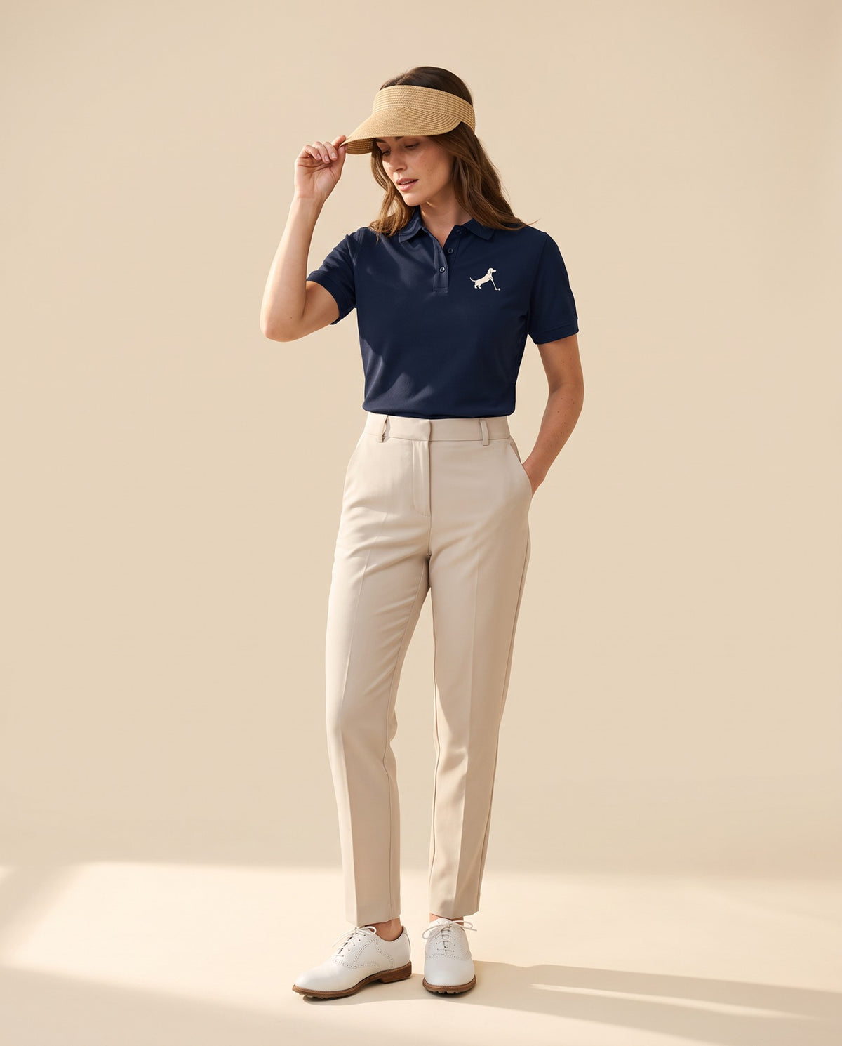 Woman wearing Putting dachshund golf polo, full-body studio look. Color: Navy Blue