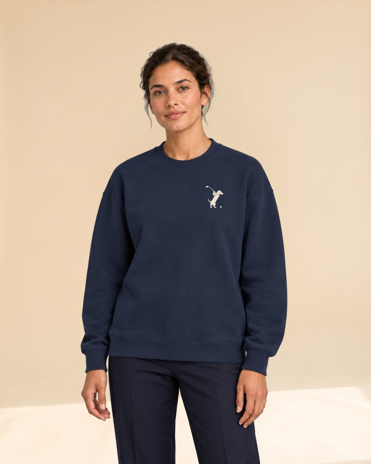 Woman wearing Swing dachshund golf sweatshirt, front studio view. Color: Navy
