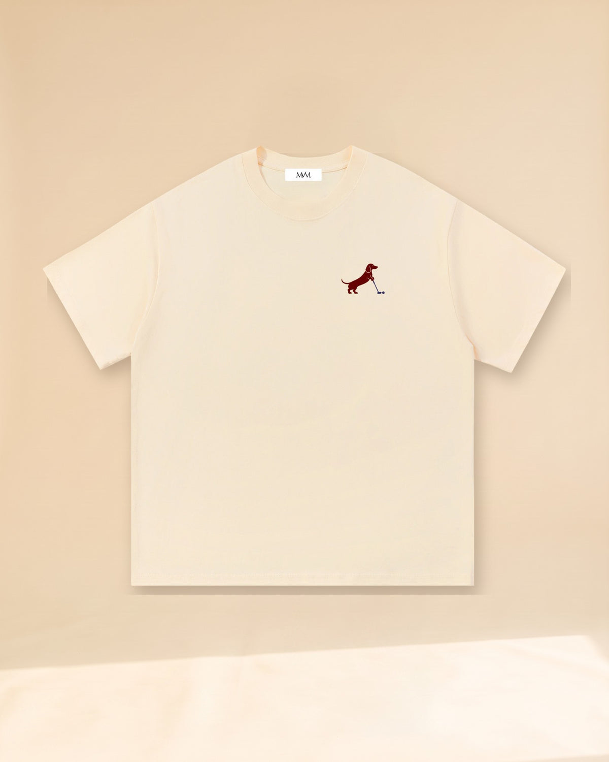 Putting dachshund golf T-shirt, front view. Color: Apricot