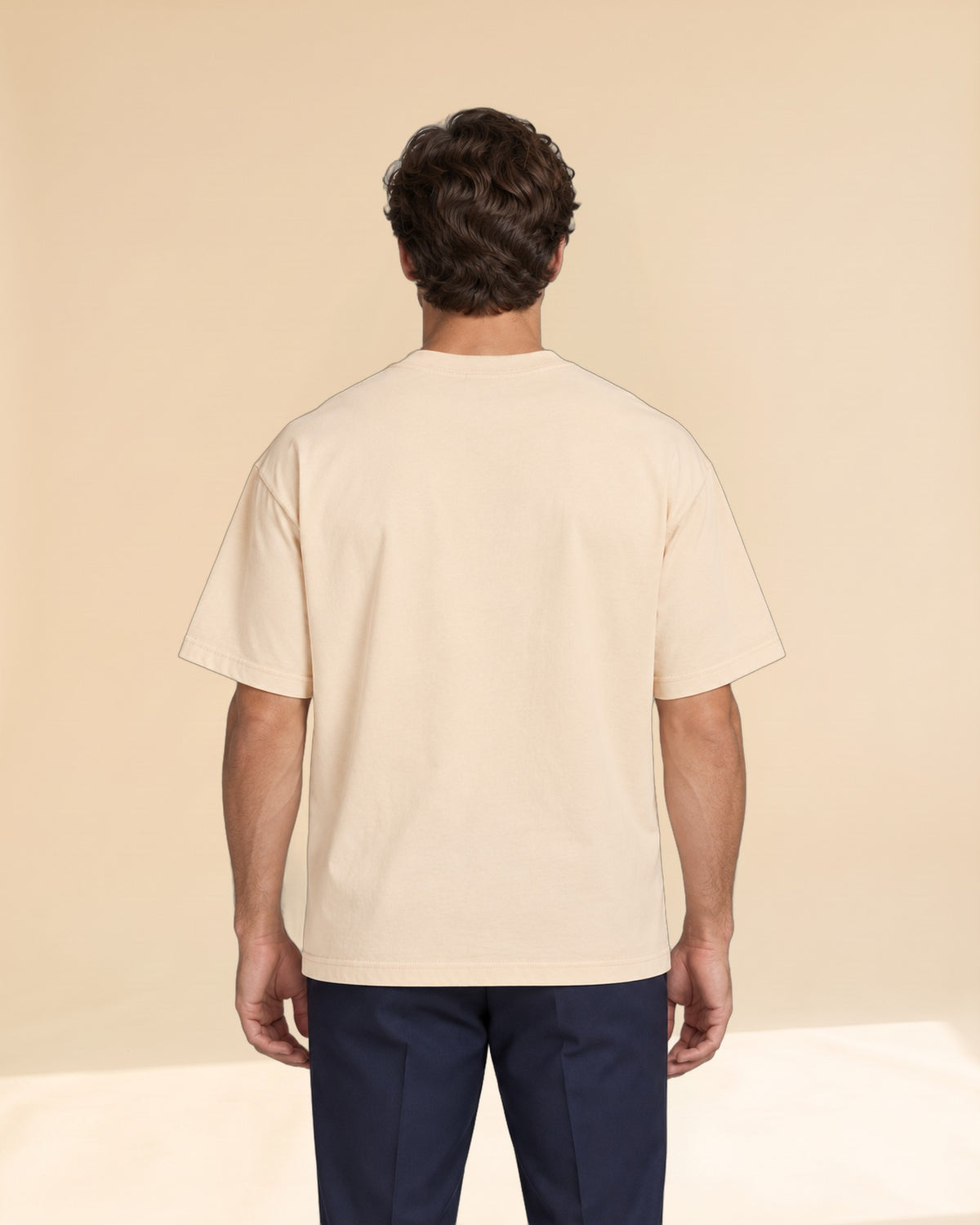 Man wearing Putting dachshund golf T-shirt, back studio view. Color: Apricot