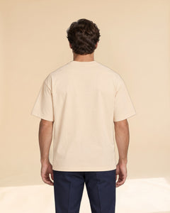 Man wearing Putting dachshund golf T-shirt, back studio view. Color: Apricot