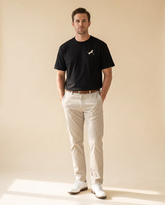 Man wearing Putting dachshund golf T-shirt, full-body studio look. Color: Black
