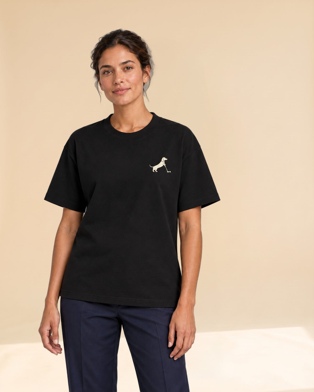 Woman wearing Putting dachshund golf T-shirt, front studio view. Color: Black