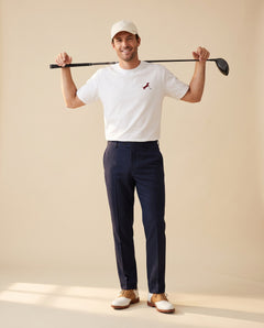 Man wearing Putting dachshund golf T-shirt, full-body studio look. Color: White