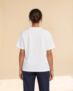 Woman wearing Putting dachshund golf T-shirt, back studio view. Color: White