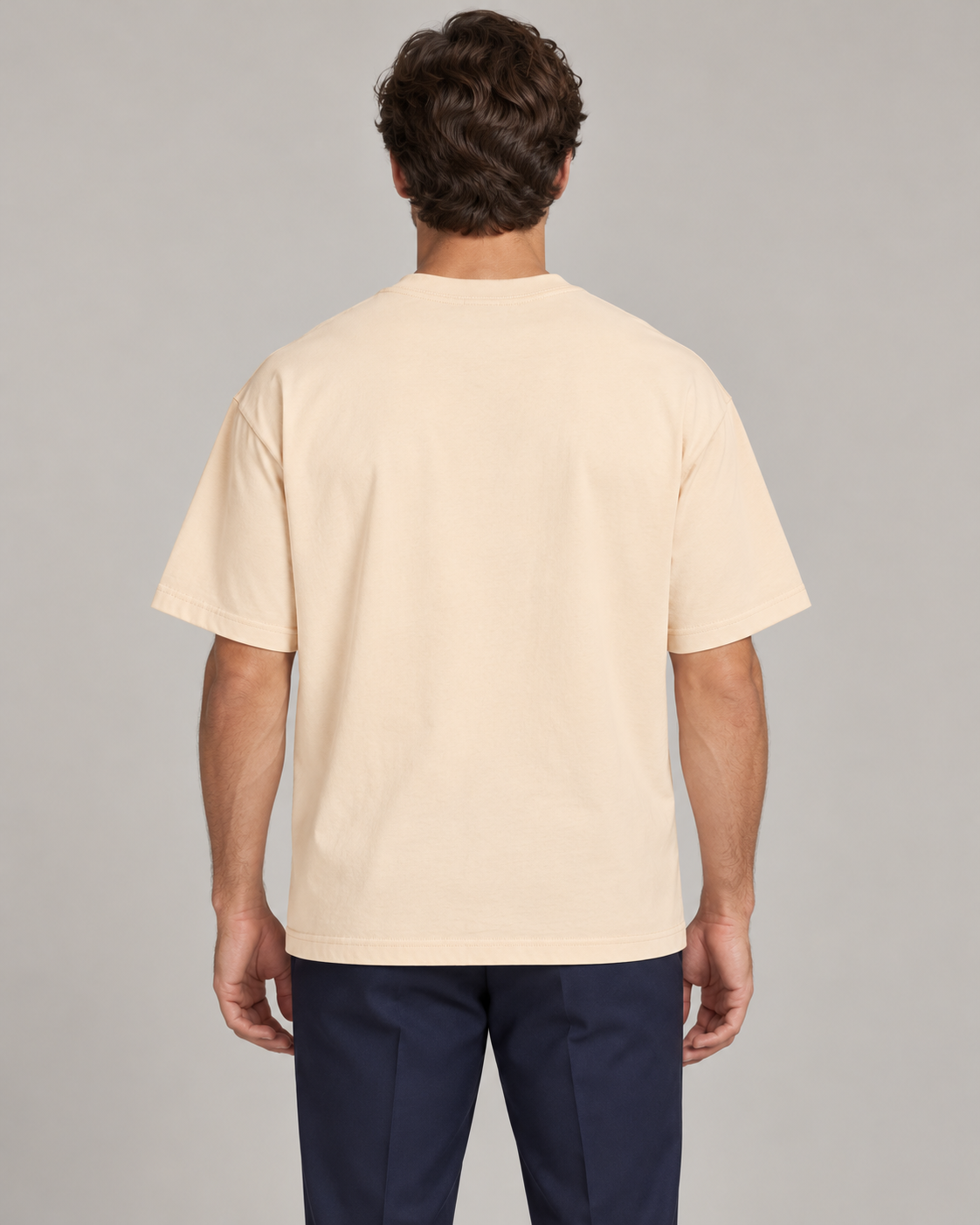 Man wearing Putting dachshund golf T-shirt, back studio view. Color: Apricot