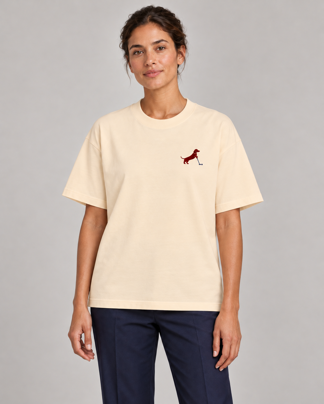 Woman wearing Putting dachshund golf T-shirt, front studio view. Color: Apricot