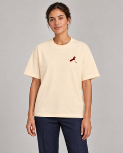 Woman wearing Putting dachshund golf T-shirt, front studio view. Color: Apricot