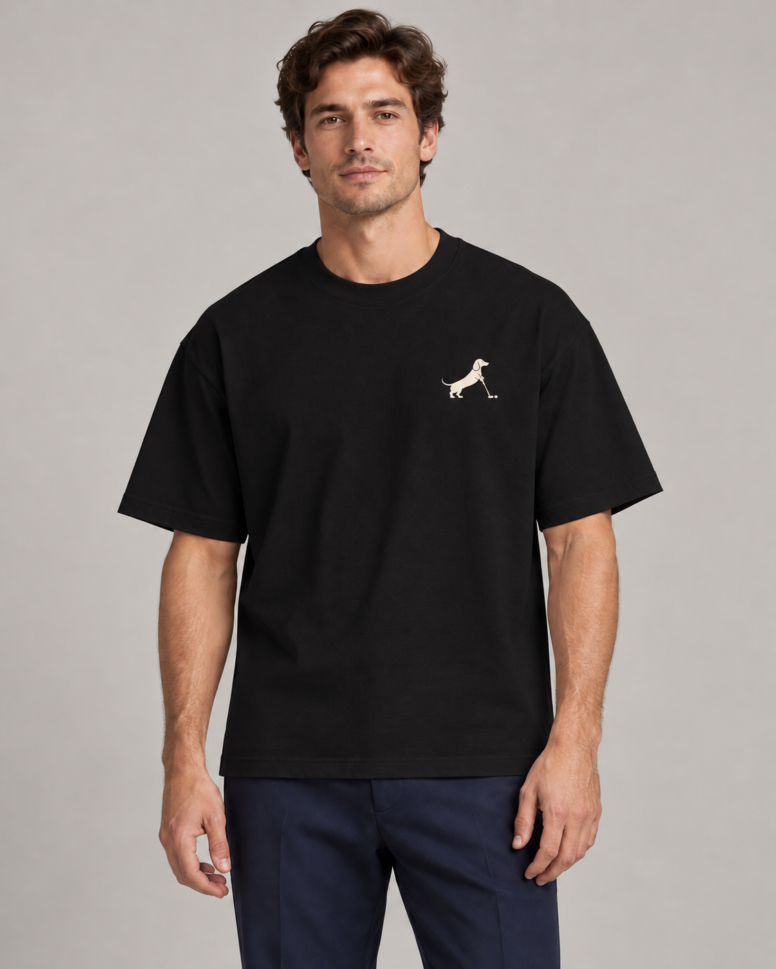 Man wearing Putting dachshund golf T-shirt, front studio view. Color: Black