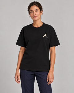 Woman wearing Putting dachshund golf T-shirt, front studio view. Color: Black