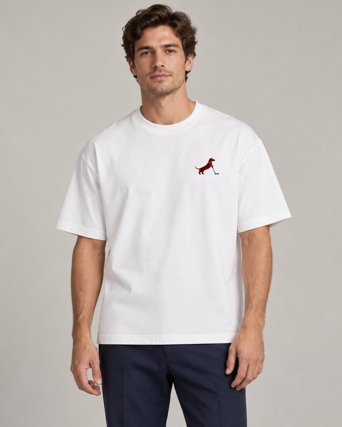 Man wearing Putting dachshund golf T-shirt, front studio view. Color: White