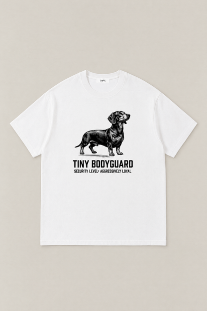 Tiny Bodyguard Dachshund Tee in white, flat lay front view. Color: White