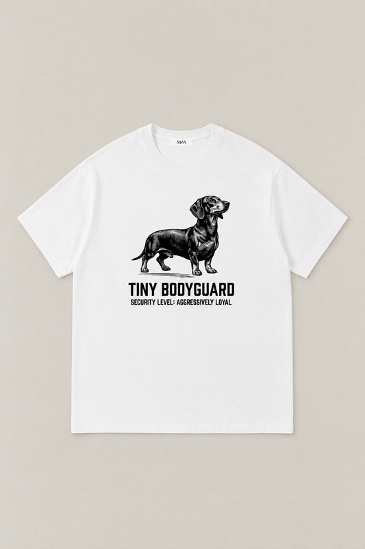 Tiny Bodyguard Dachshund Tee in white, flat lay front view. Color: White