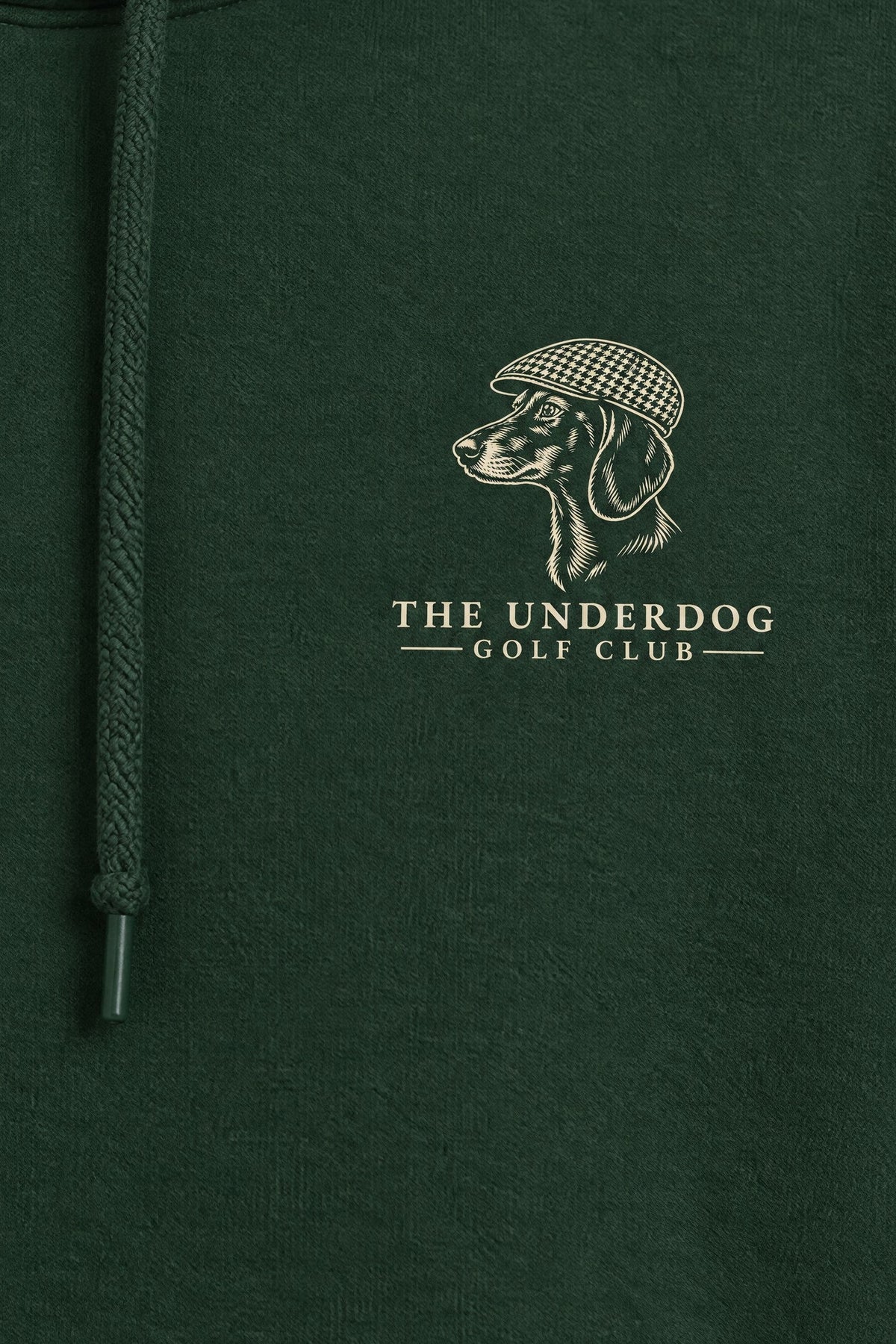 Close-up of The Underdog Golf Club dachshund crest printed on the left chest of the Blackish Green hoodie. Color: Blackish Green