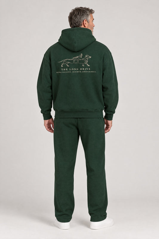 Man seen from behind in The Long Drive dachshund golf hoodie in Blackish Green, showing the large back print. Color: Blackish Green