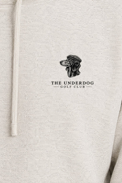Close-up of The Underdog Golf Club dachshund crest printed on the left chest of the Oat Gray hoodie. Color: Oat Gray