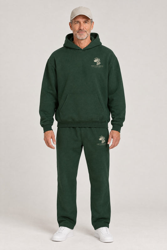 Man wearing The Sweet Spot Dalmatian golf hoodie and matching Underdog Golf Club sweatpants in Blackish Green, front view. Color: Blackish Green