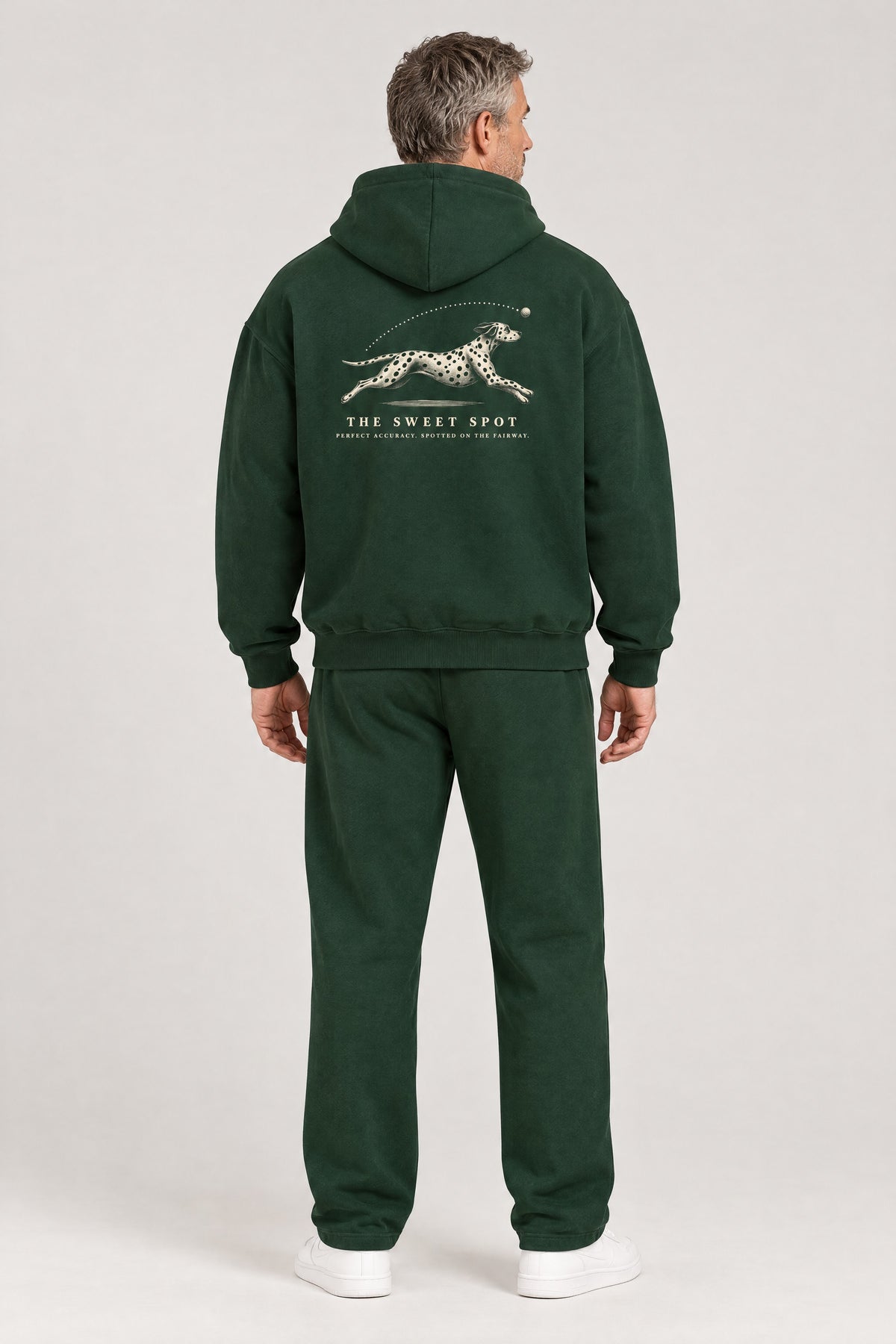 Man seen from behind in The Sweet Spot Dalmatian golf hoodie in Blackish Green, showing the large back print. Color: Blackish Green
