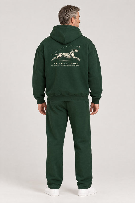Man seen from behind in The Sweet Spot Dalmatian golf hoodie in Blackish Green, showing the large back print. Color: Blackish Green
