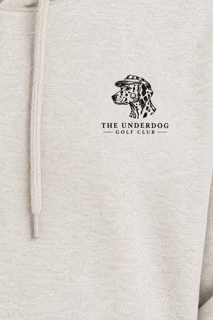 Close-up of The Underdog Golf Club Dalmatian crest printed on the left chest of the Oat Gray hoodie. Color: Oat Gray