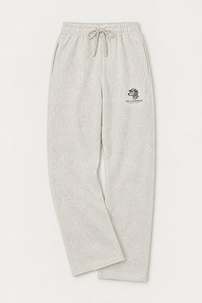 Flat lay of Underdog Golf Club Dalmatian crest sweatpants in Oat Gray. Color: Oat Gray