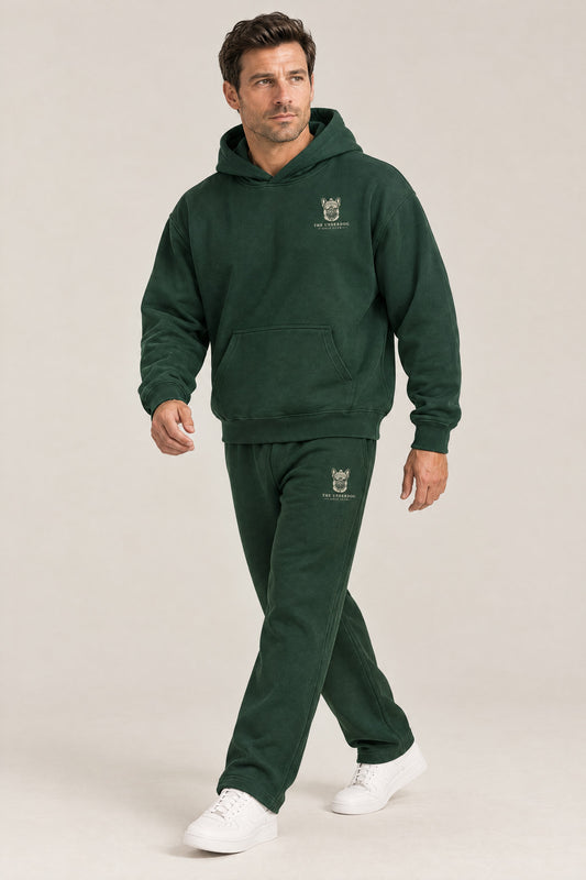 Man walking in The Marshal French Bulldog golf hoodie and sweatpants set in Blackish Green. Color: Blackish Green