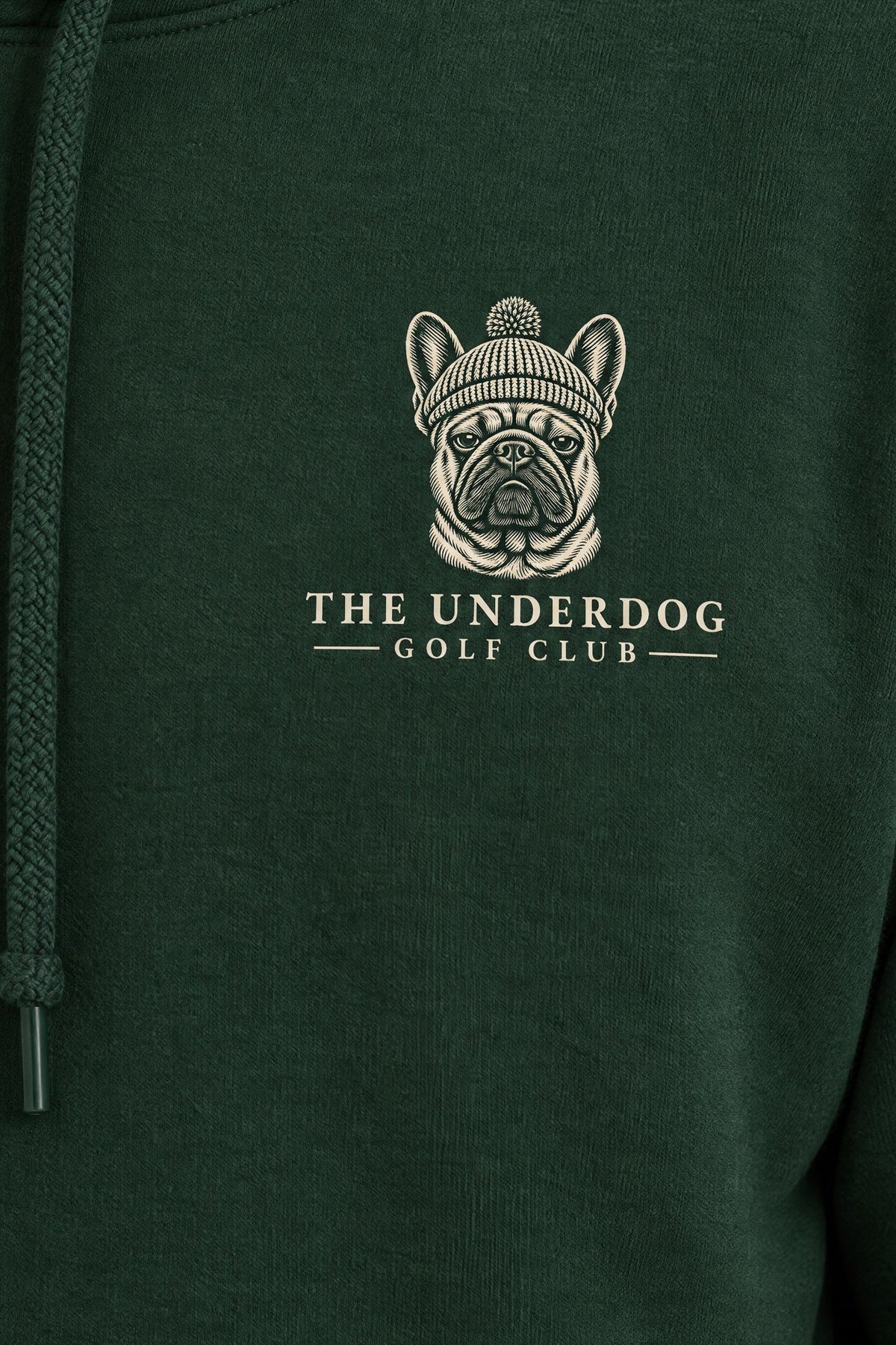 Close-up of The Underdog Golf Club French Bulldog crest printed on the left chest of the Blackish Green hoodie. Color: Blackish Green