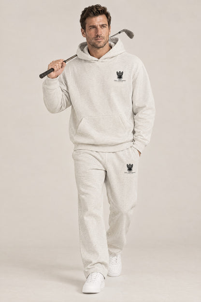 Man walking in The Marshal French Bulldog golf hoodie and sweatpants set in Oat Gray. Color: Oat Gray