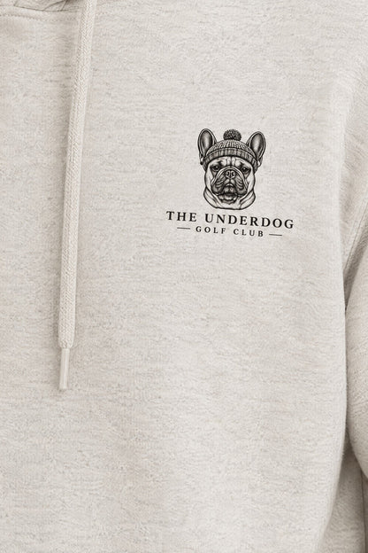 Close-up of The Underdog Golf Club French Bulldog crest printed on the left chest of the Oat Gray hoodie. Color: Oat Gray