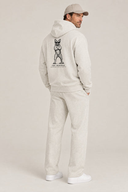 Man seen from behind in The Marshal French Bulldog golf hoodie in Oat Gray, showing the large back print. Color: Oat Gray
