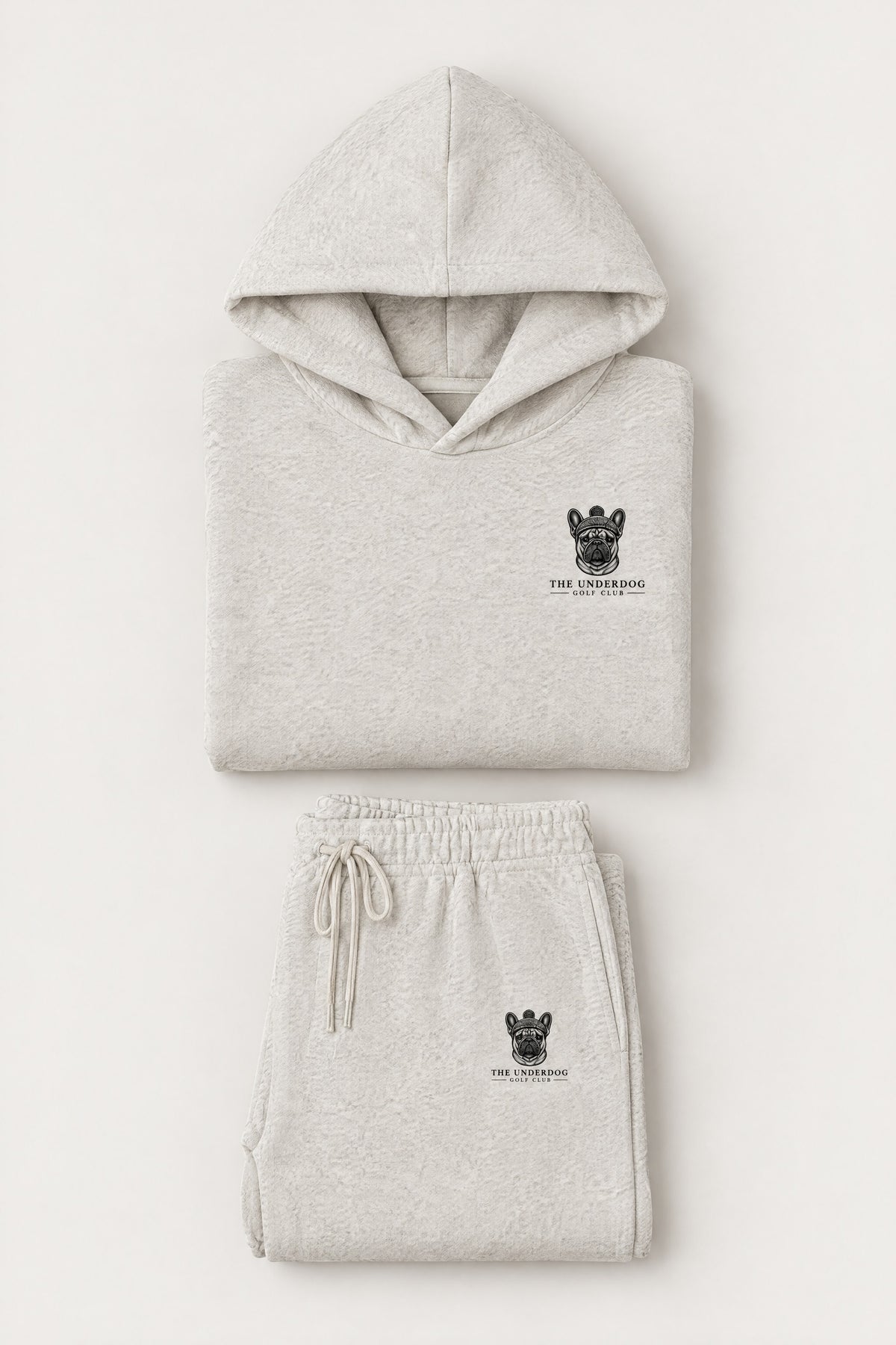 Flat lay of The Marshal French Bulldog golf hoodie and matching sweatpants in Oat Gray. Color: Oat Gray