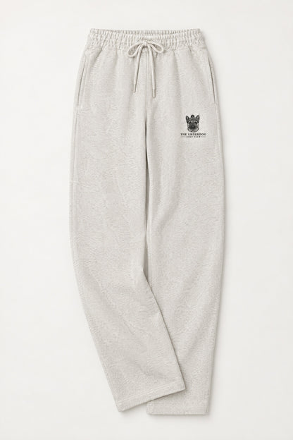 Flat lay of Underdog Golf Club French Bulldog crest sweatpants in Oat Gray. Color: Oat Gray