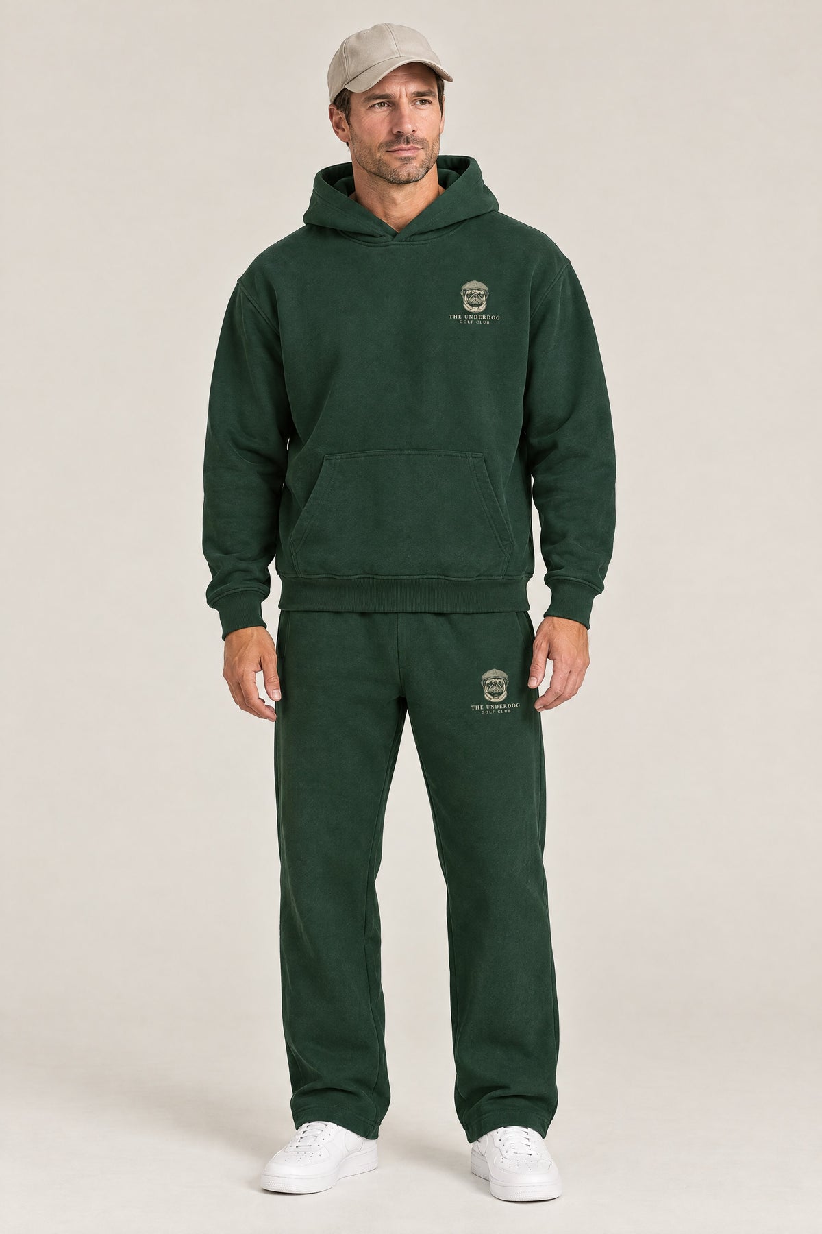 Man wearing The Heavy Hitter pug golf hoodie and matching Underdog Golf Club sweatpants in Blackish Green, front view. Color: Blackish Green