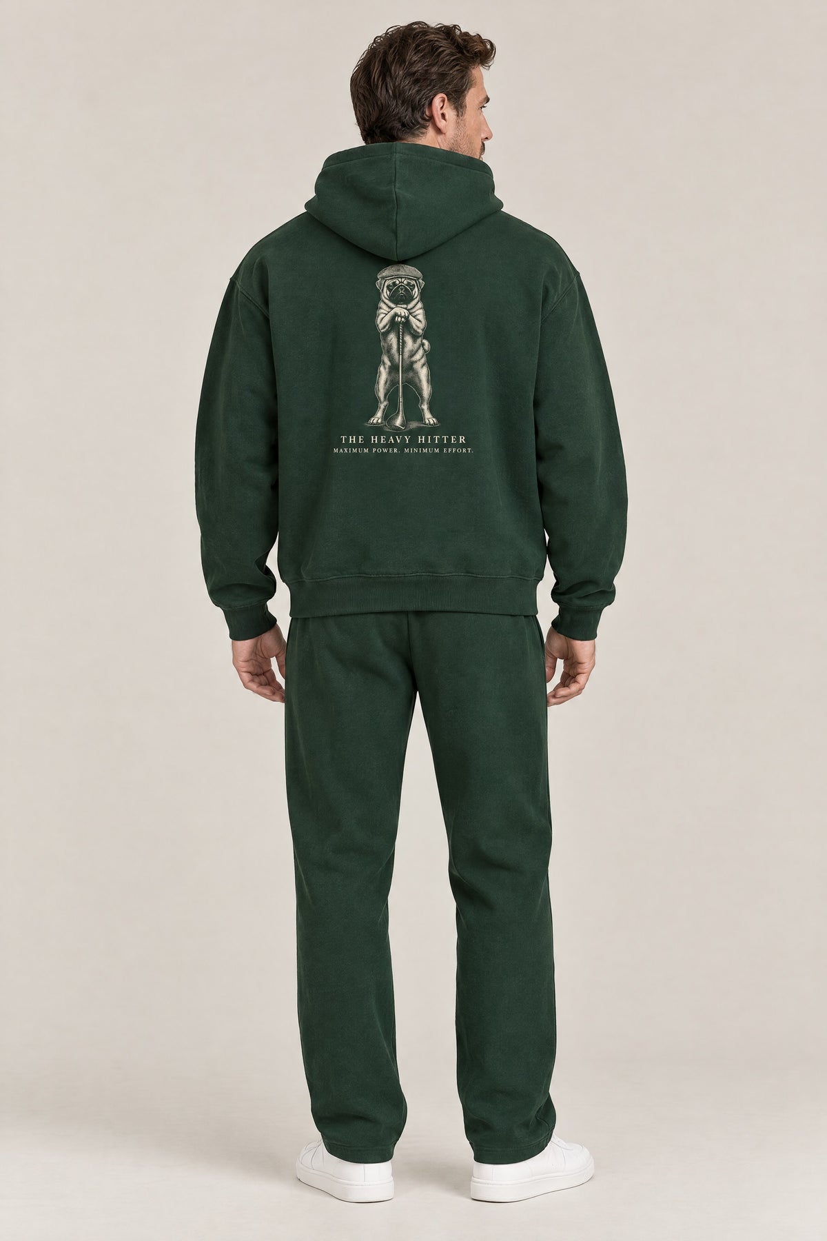 Man seen from behind in The Heavy Hitter pug golf hoodie in Blackish Green, showing the large back print. Color: Blackish Green