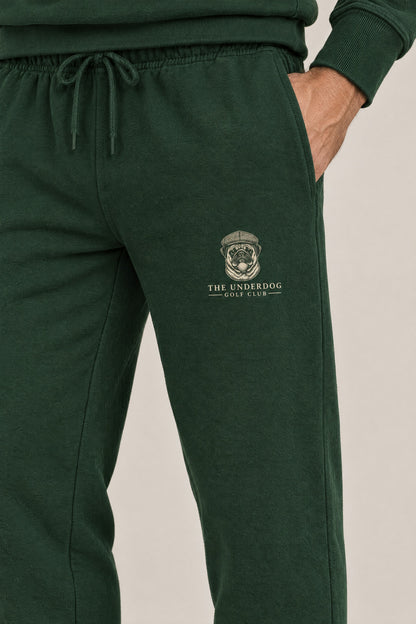 Close-up of The Underdog Golf Club pug crest on the left thigh of the Blackish Green sweatpants. Color: Blackish Green