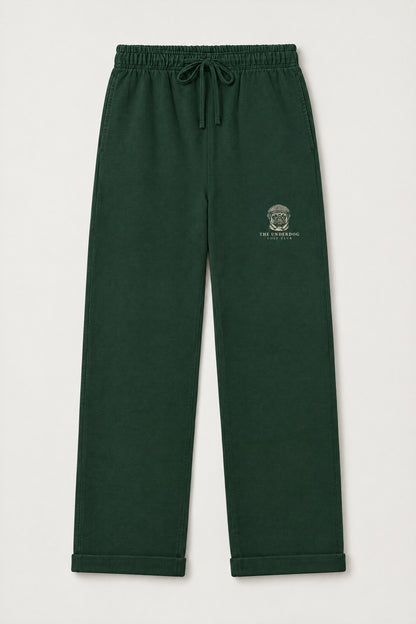 Flat lay of Underdog Golf Club pug crest sweatpants in Blackish Green. Color: Blackish Green