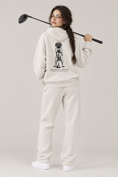 Woman with a driver over her shoulder, back view of The Heavy Hitter pug golf hoodie in Oat Gray with the large back print. Color: Oat Gray