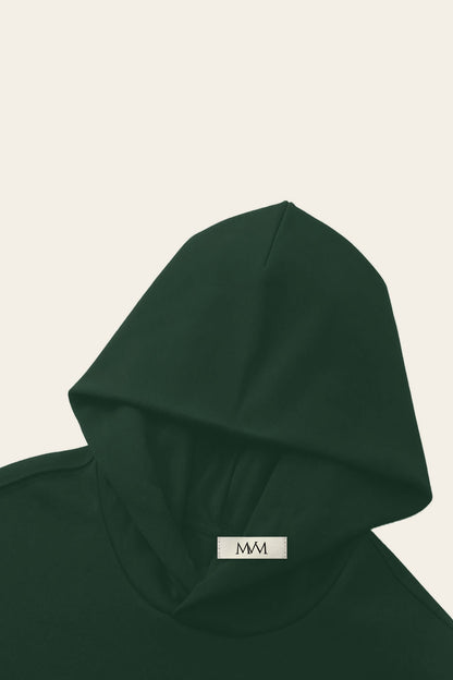 Detail of the hood of the blackish green Underdog Golf Club hoodie with the MVM woven neck label. Color: Blackish Green