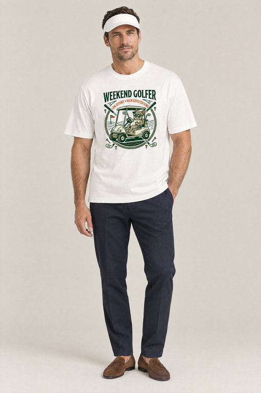 Man wearing the Weekend Golfer French Bulldog Golf Tee in white with navy trousers and a white visor. Color: White