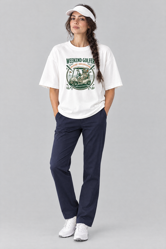 Woman wearing the Weekend Golfer French Bulldog Golf Tee in white with navy trousers and a white visor. Color: White